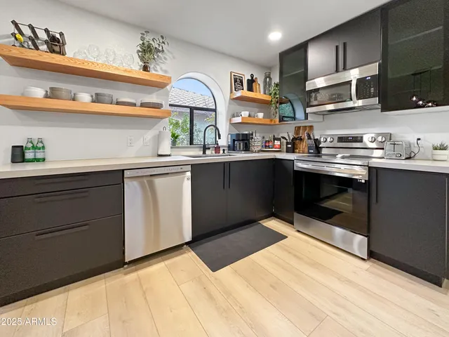a kitchen with stainless steel appliances granite countertop a sink and cabinets