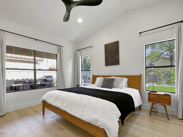 a bedroom with a large bed and a large window