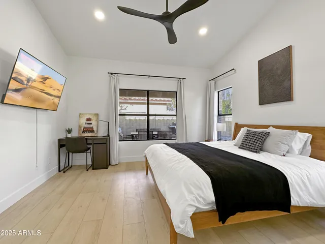 a bedroom with a bed and wooden floor