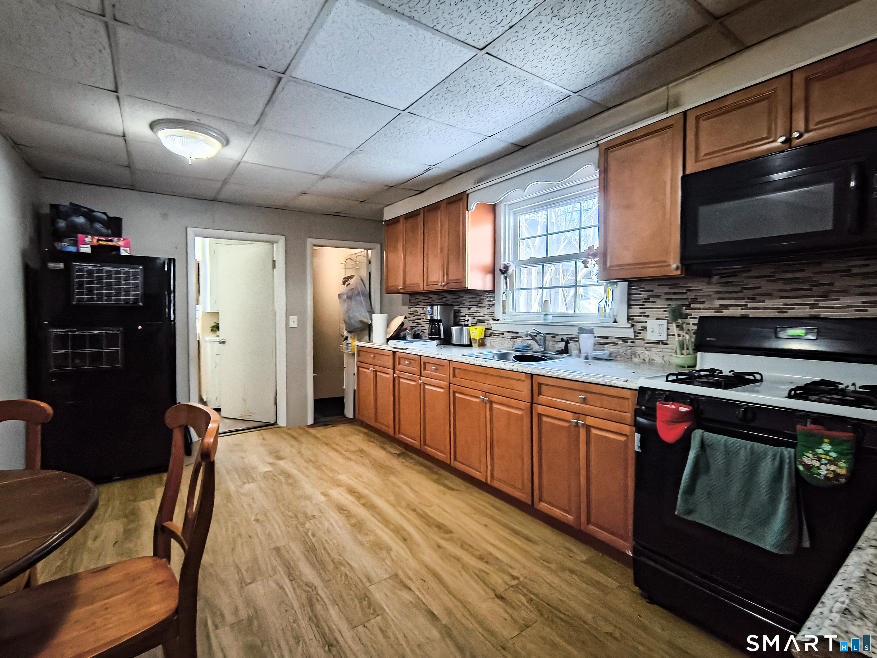 70 Walnut Street Putnam, CT 06260 - Photo 11 of 20 a kitchen with stainless steel appliances granite countertop a stove sink microwave and refrigerator