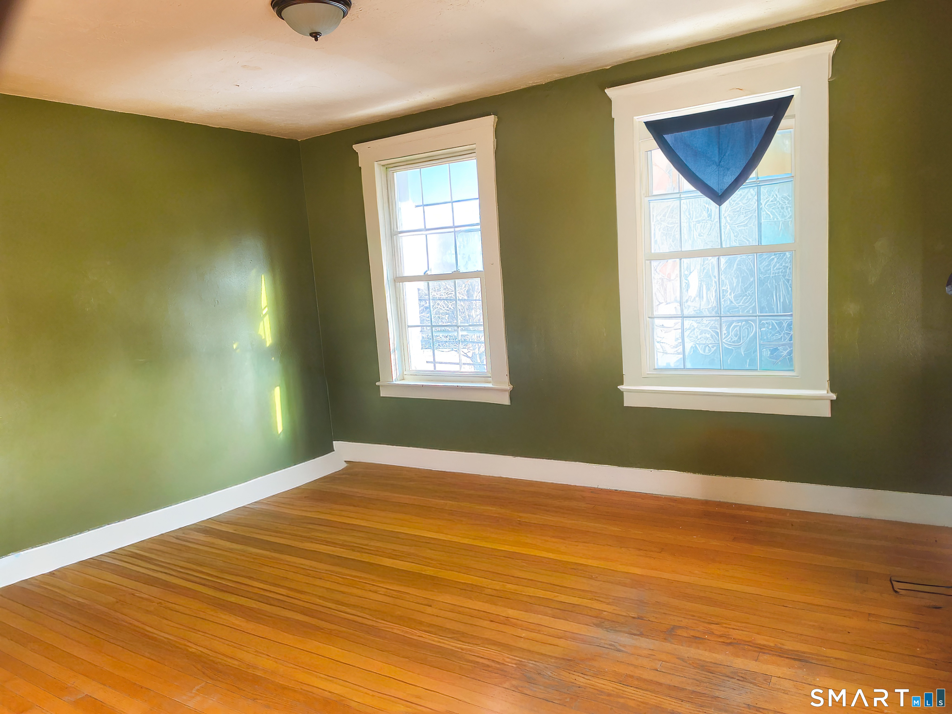 70 Walnut Street Putnam, CT 06260 - Photo 9 of 20 a view of empty room with wooden floor and fan