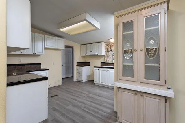 a kitchen with granite countertop a refrigerator and a stove