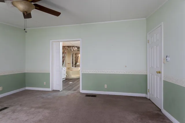 an empty room with closet and windows