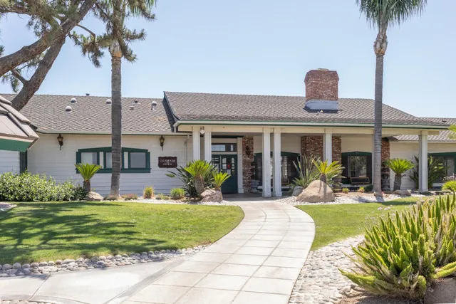 a front view of a house with a yard table and chairs