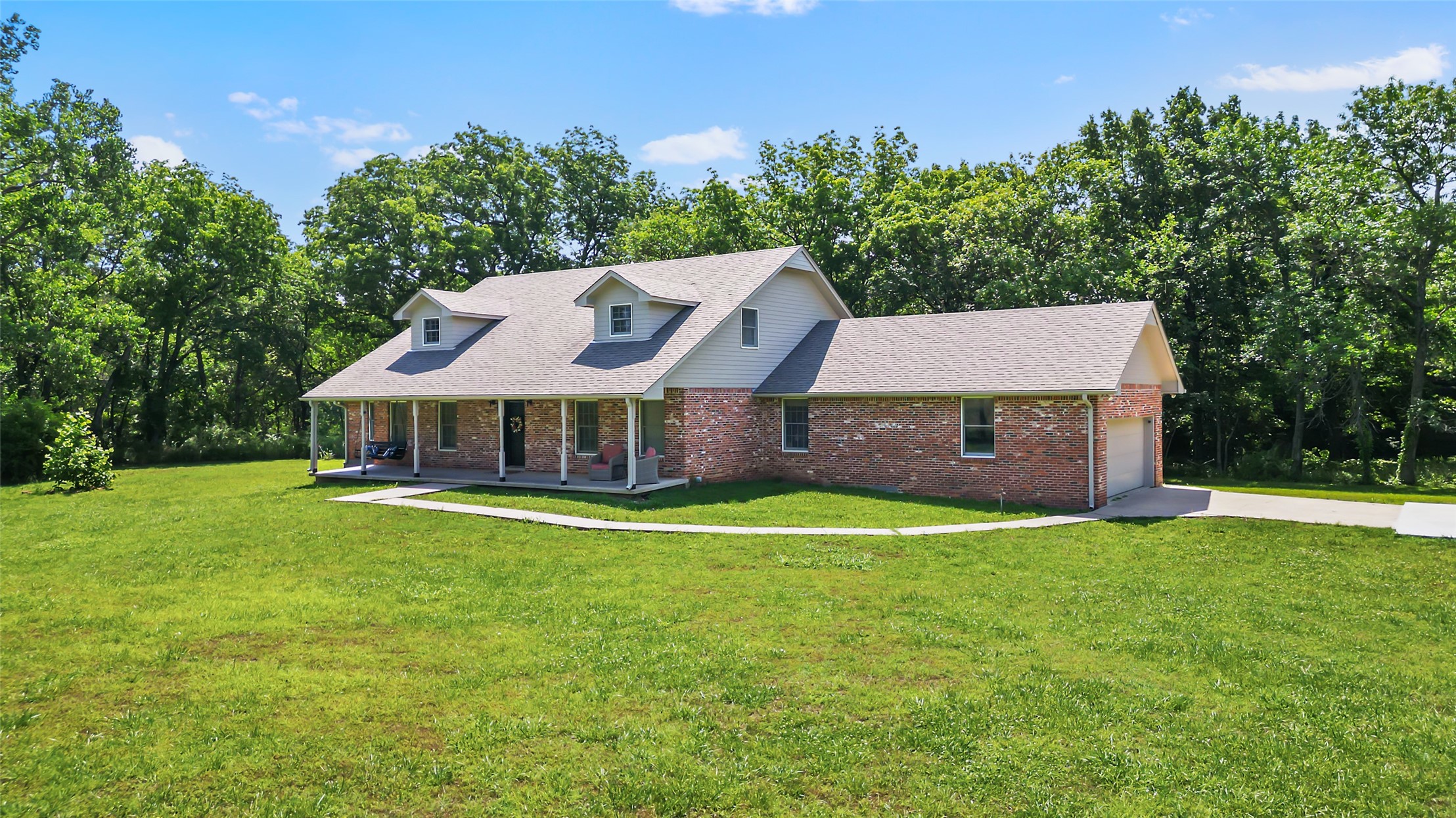 9644 19th Road Nowata, OK 74048 - Photo 33 of 36 Brick exterior residence with a covered front porch featuring white columns