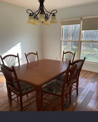 a view of a room with wooden floor