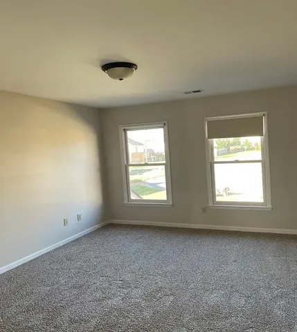 a view of a balcony with a floor to ceiling window next to a road