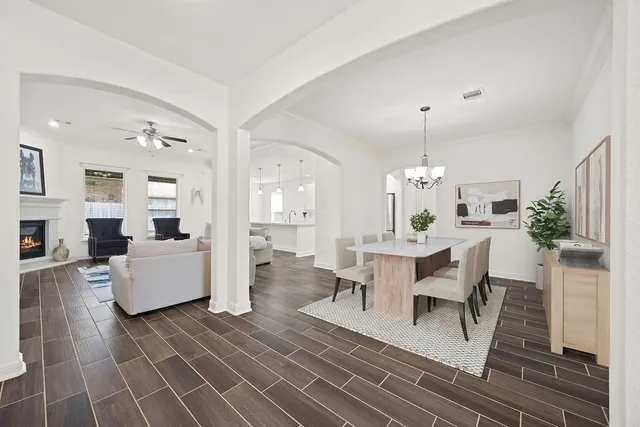 a view of a dining room with furniture wooden floor and a chandelier