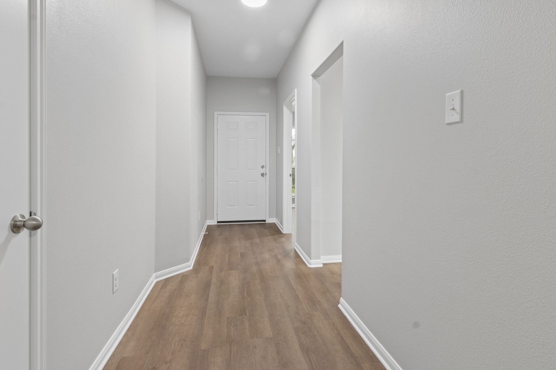 7811 Adonis Avenue Baytown, TX 77521 - Photo 7 of 36 a view of a hallway with wooden floor