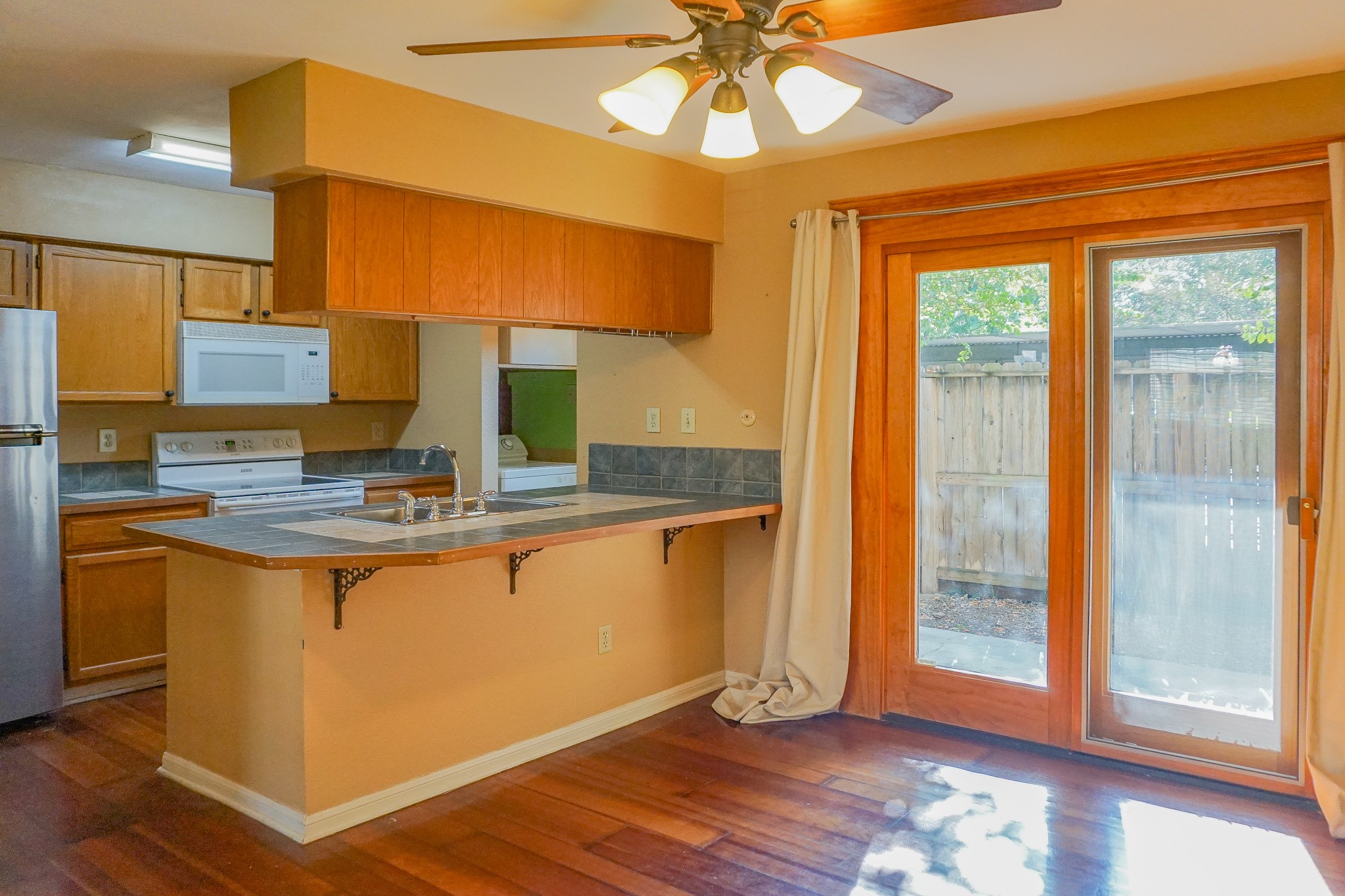 3100 Jeanetta Street, Unit 703 Houston, TX 77063 - Photo 11 of 42 a kitchen with stainless steel appliances granite countertop a sink and a refrigerator