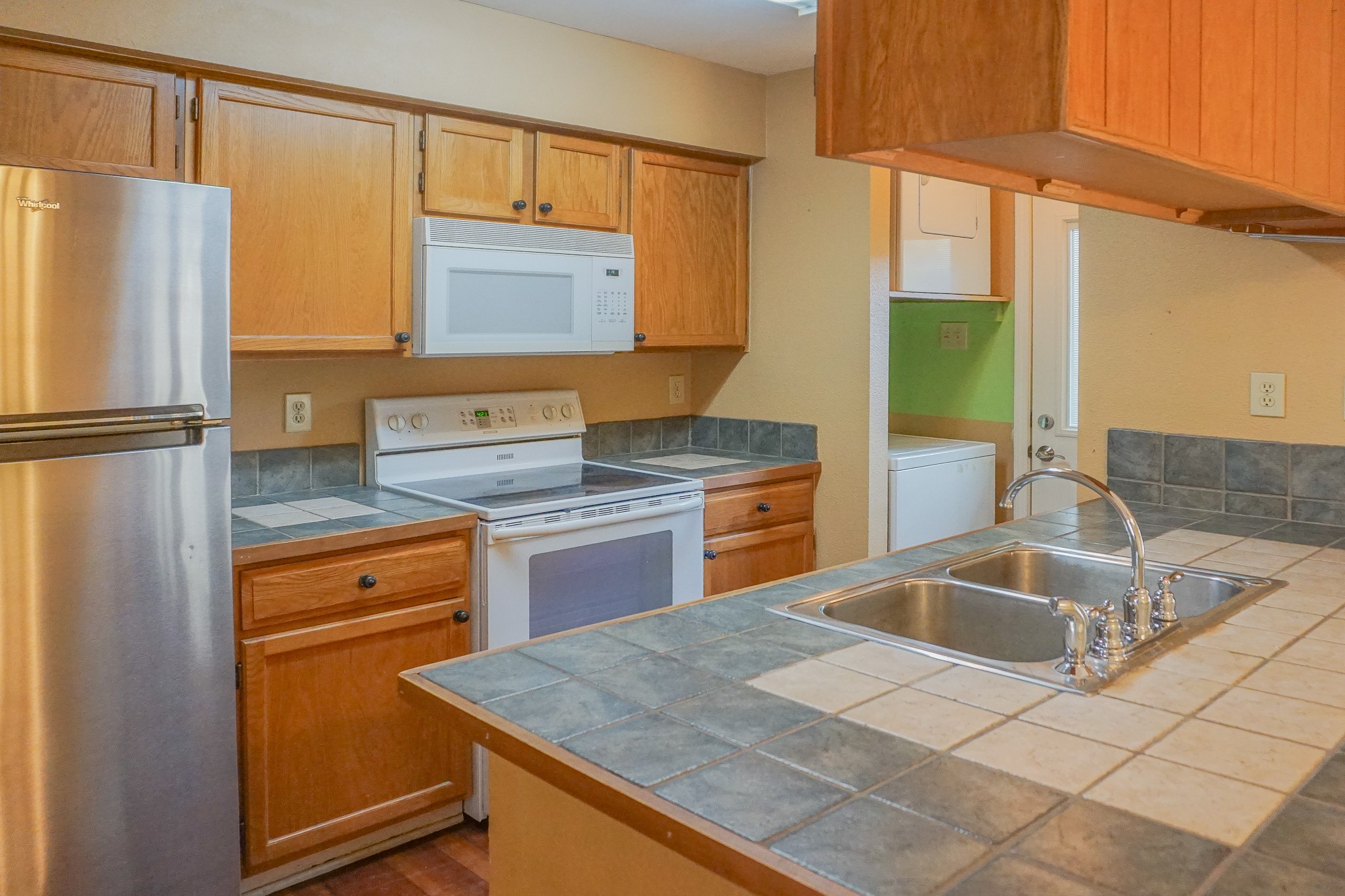 3100 Jeanetta Street, Unit 703 Houston, TX 77063 - Photo 12 of 42 a kitchen with stainless steel appliances granite countertop a sink refrigerator and cabinets