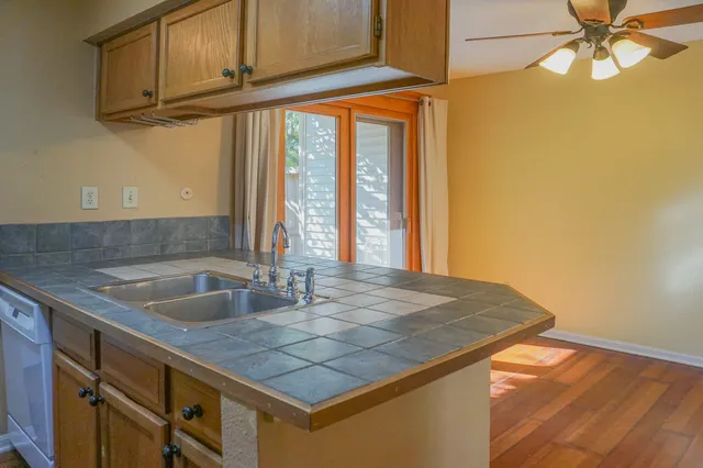 a kitchen with a sink a counter top space and cabinets