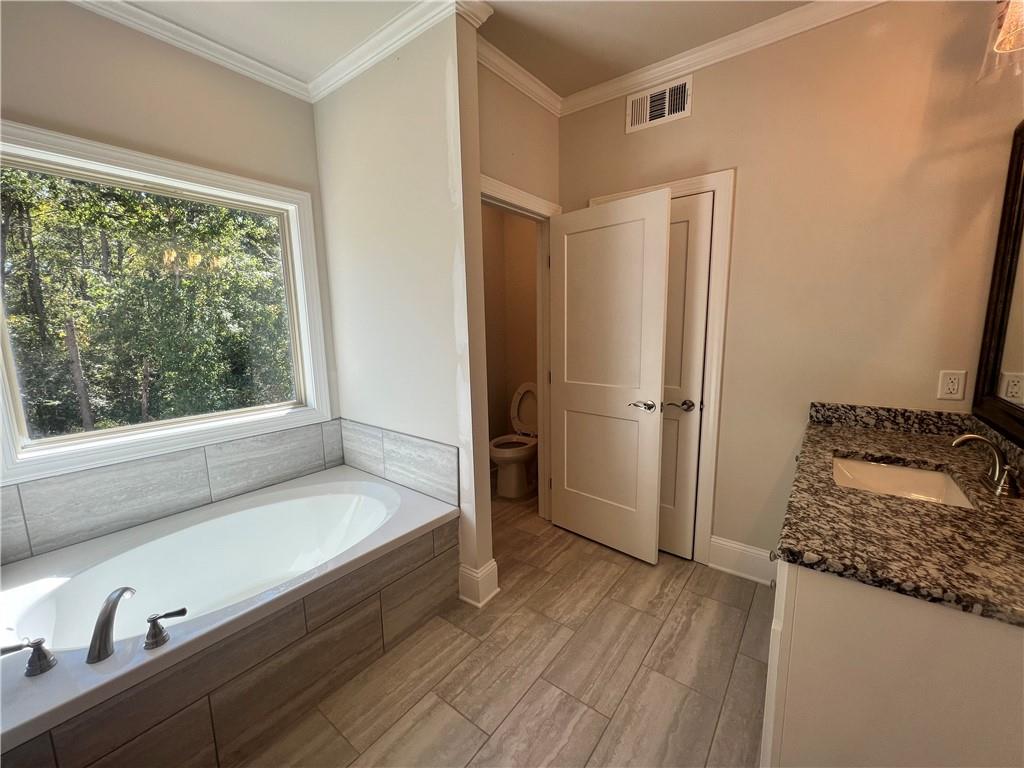 279 Adventure Trail Jefferson, GA 30549 - Photo 23 of 59 a bathroom with a bathtub and a window