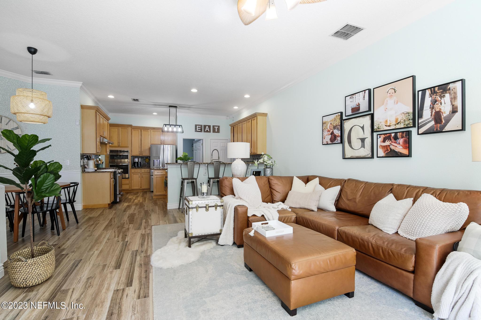 3926 Danforth Drive West Jacksonville, FL 32224 - Photo 11 of 35 a living room with furniture kitchen view and a potted plant