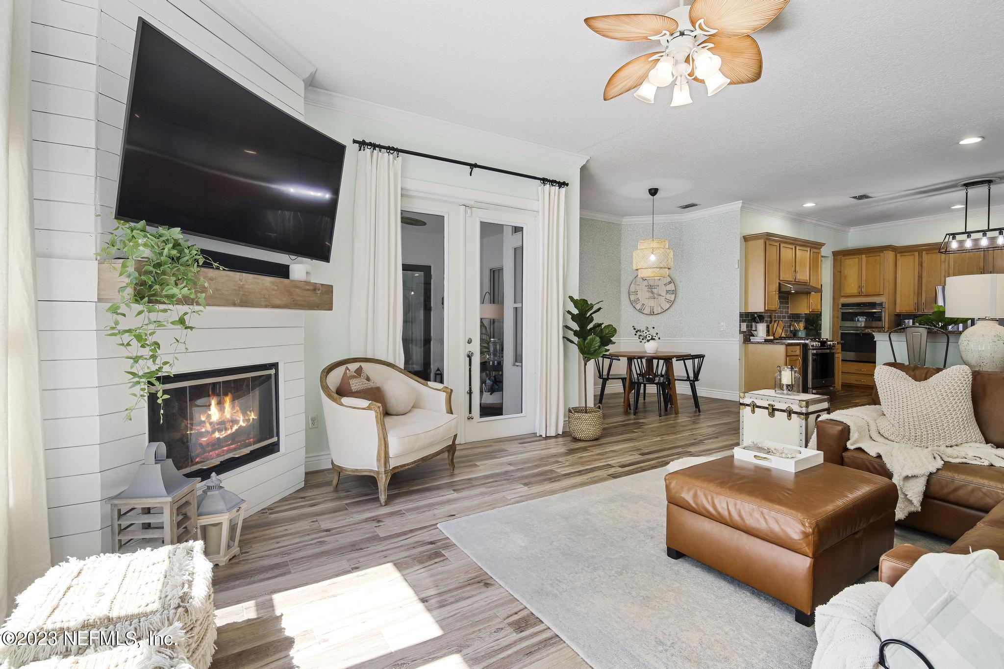 3926 Danforth Drive West Jacksonville, FL 32224 - Photo 12 of 35 a living room with furniture a fireplace and a flat screen tv