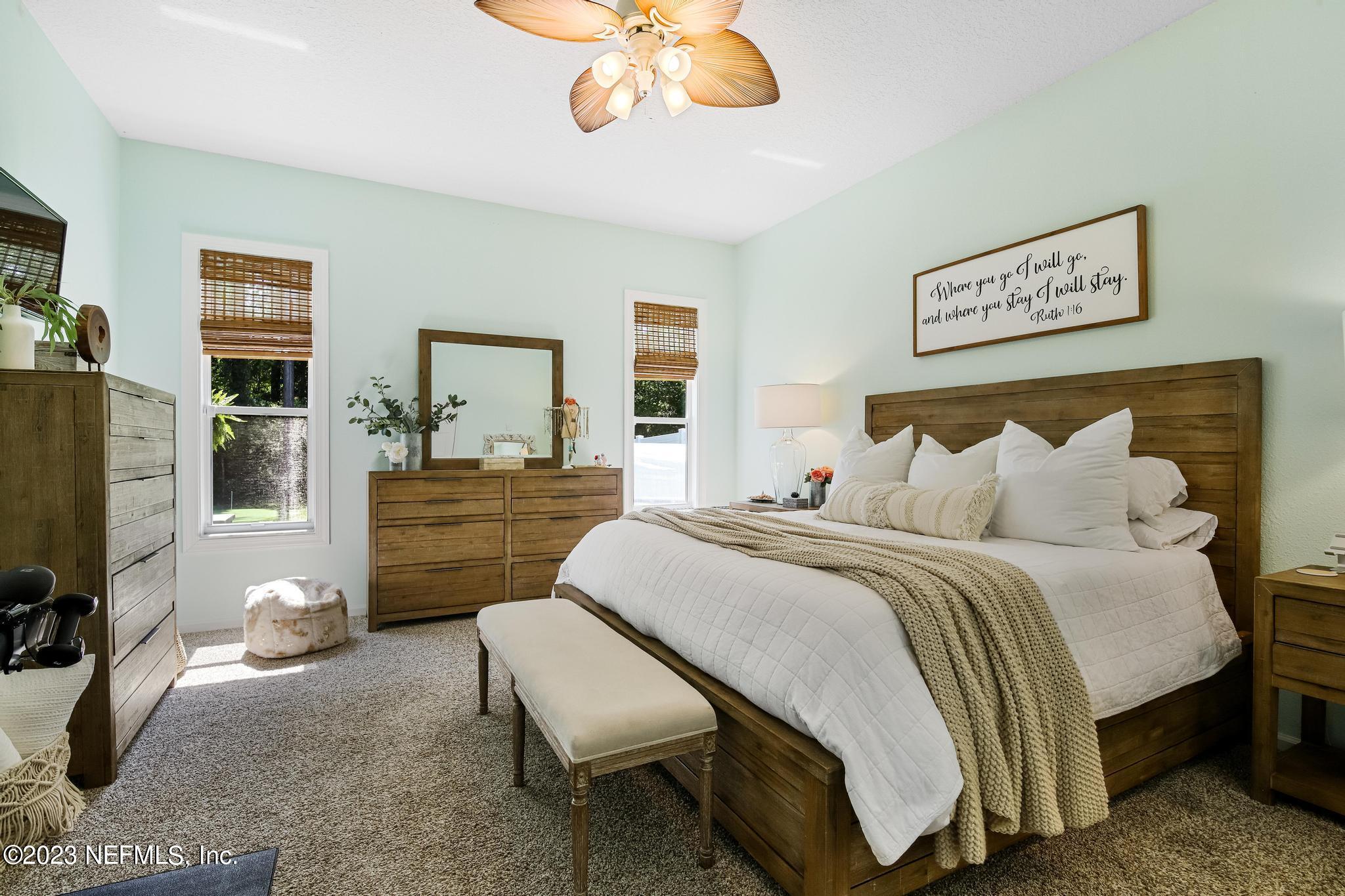 3926 Danforth Drive West Jacksonville, FL 32224 - Photo 13 of 35 a spacious bedroom with a bed and a flat screen tv