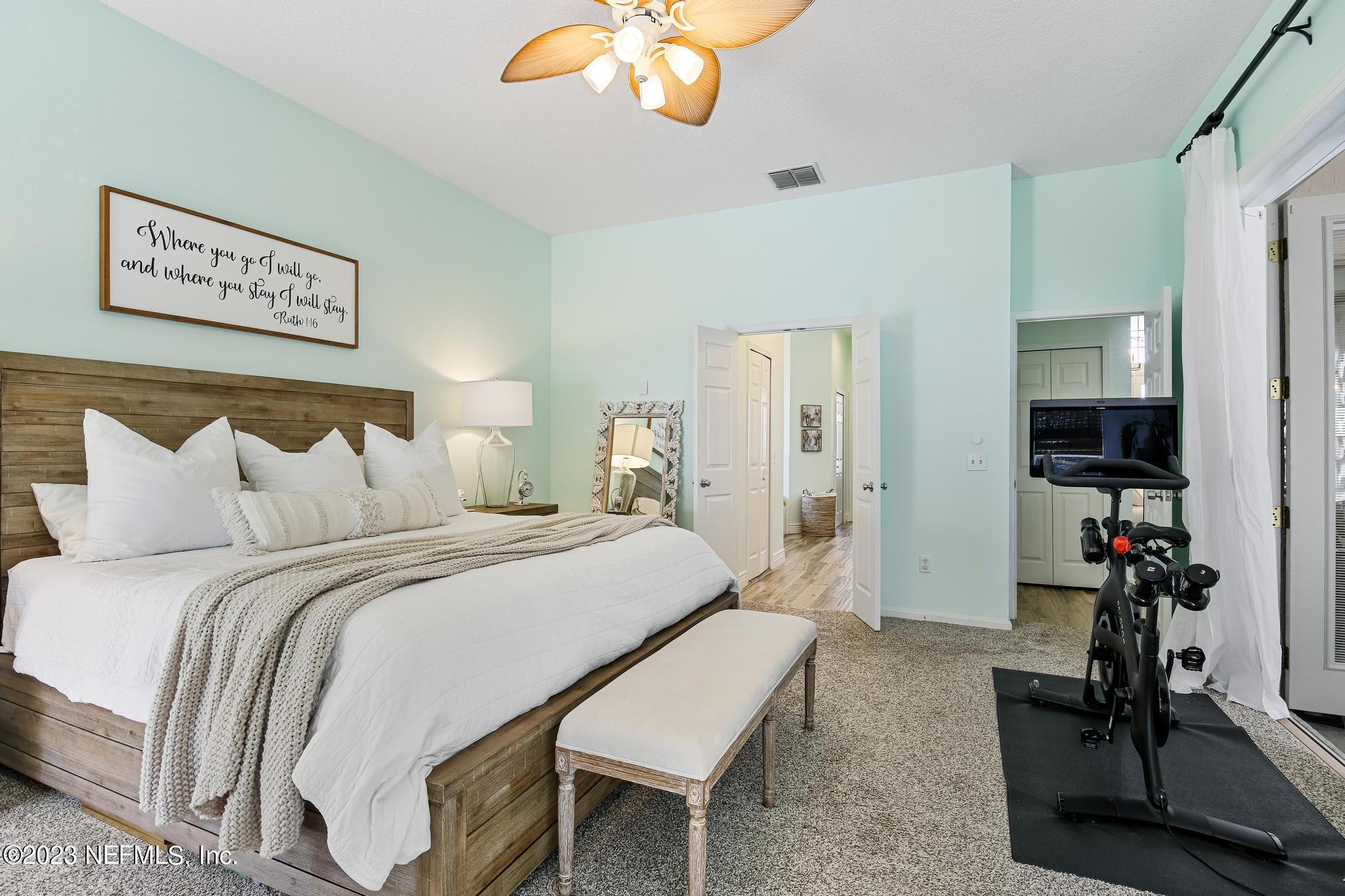 3926 Danforth Drive West Jacksonville, FL 32224 - Photo 14 of 35 a bedroom with a bed and a chandelier