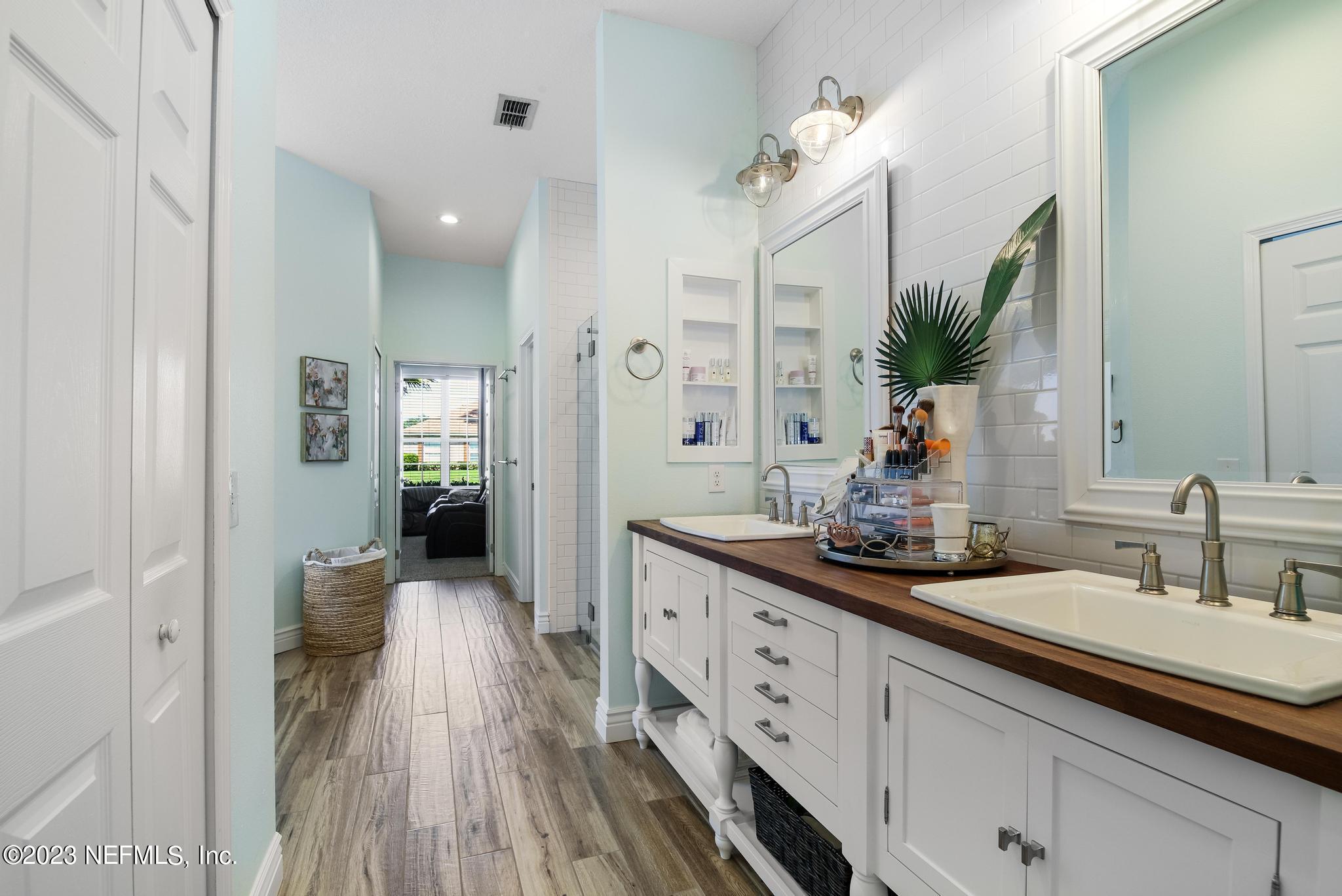 3926 Danforth Drive West Jacksonville, FL 32224 - Photo 15 of 35 a spacious en suite bathroom with a double vanity sink and mirror