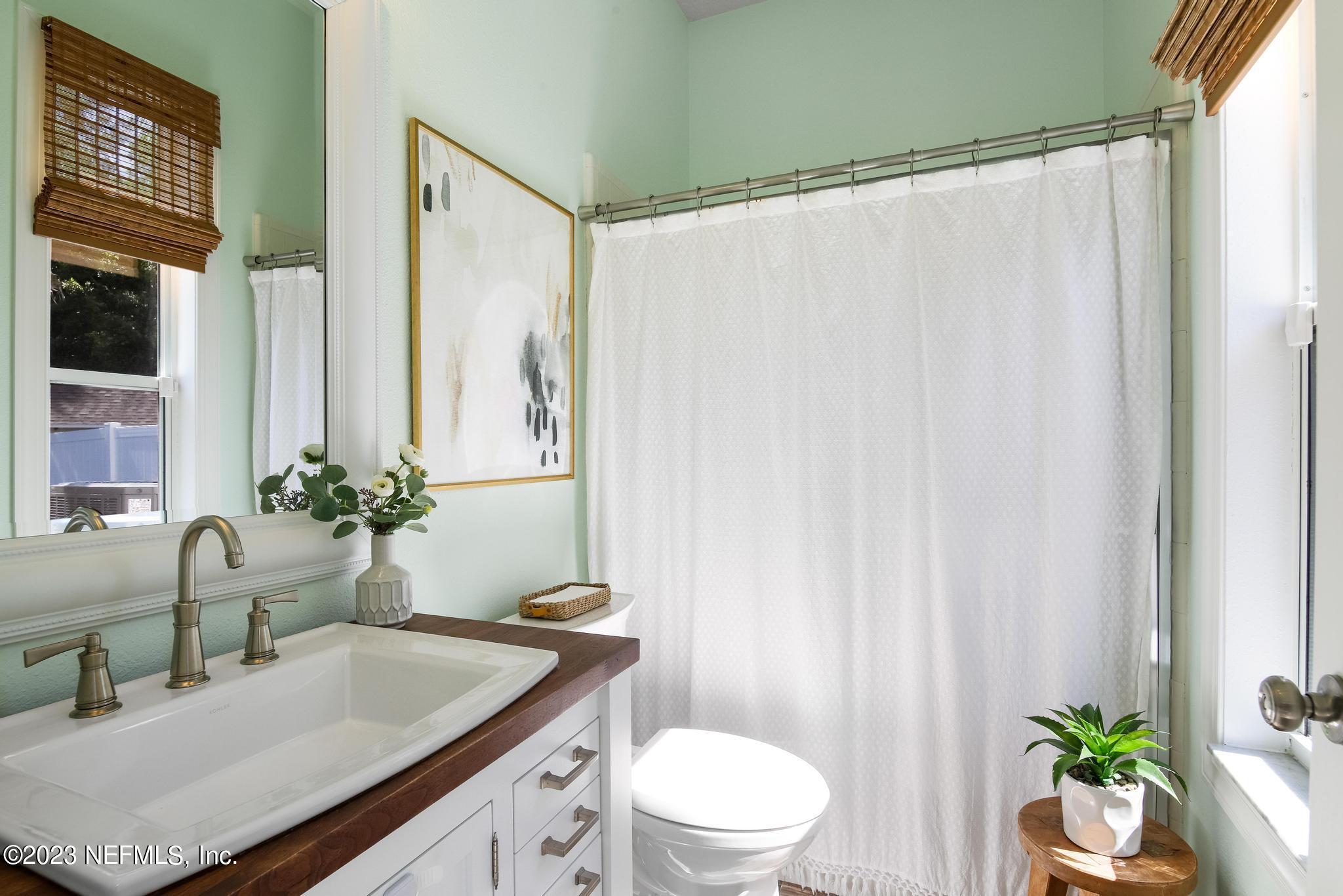 3926 Danforth Drive West Jacksonville, FL 32224 - Photo 23 of 35 a bathroom with a granite countertop sink a toilet and a mirror