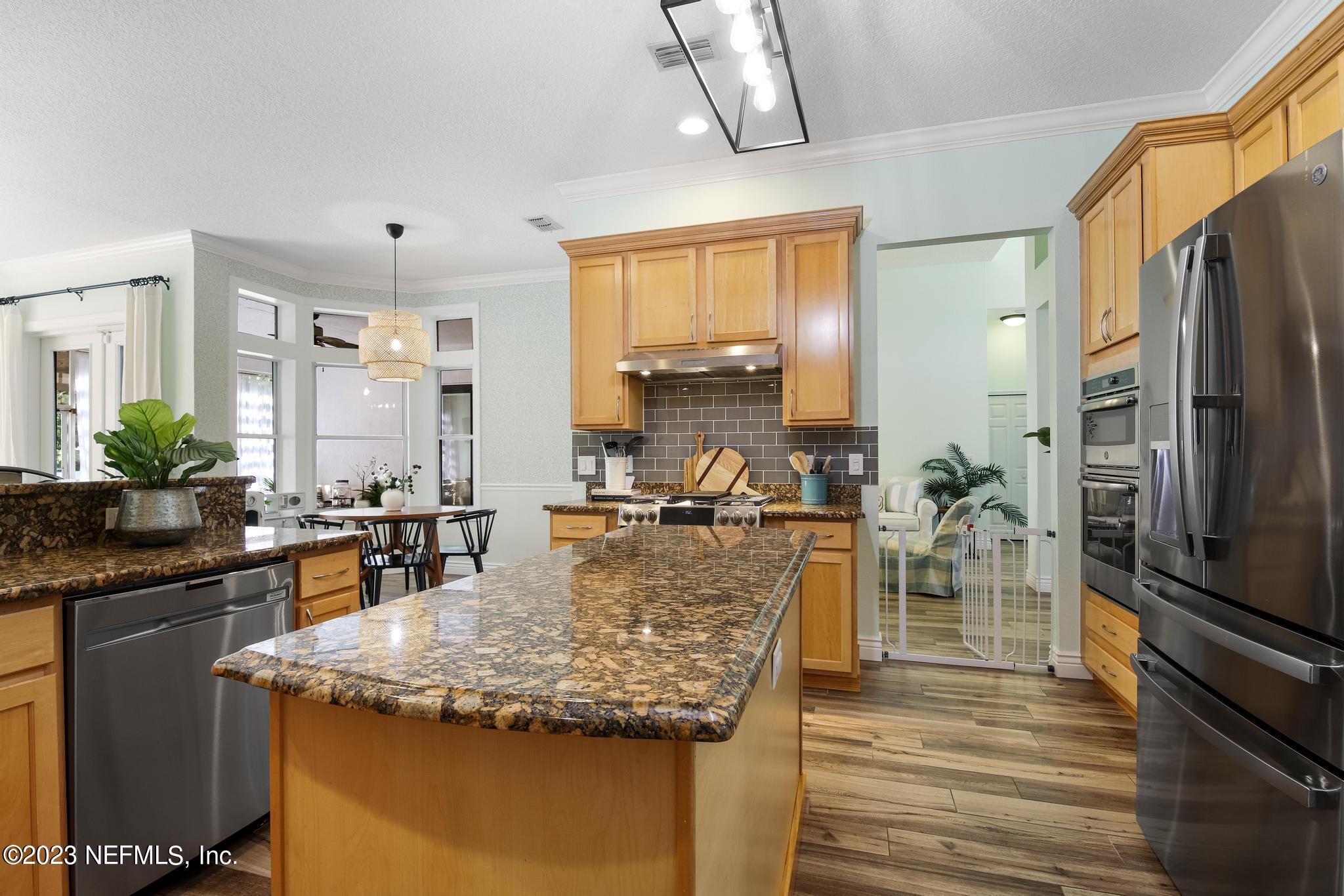 3926 Danforth Drive West Jacksonville, FL 32224 - Photo 8 of 35 a view of a kitchen with kitchen island granite countertop a large counter top appliances and cabinets