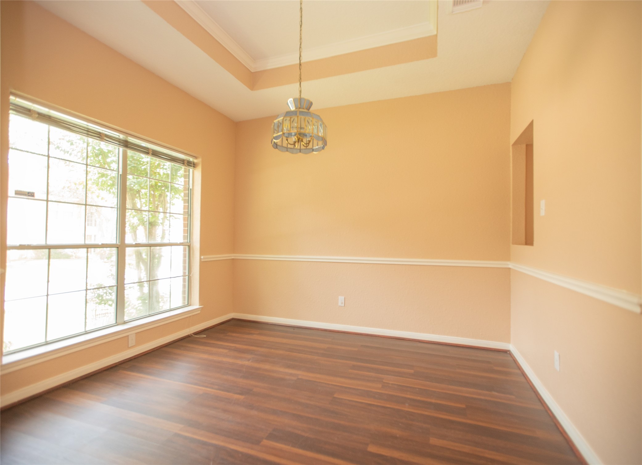 8615 Mile Run Road Humble, TX 77346 - Photo 4 of 16 a view of an empty room with wooden floor and a window