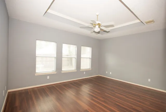 wooden floor in an empty room with a window