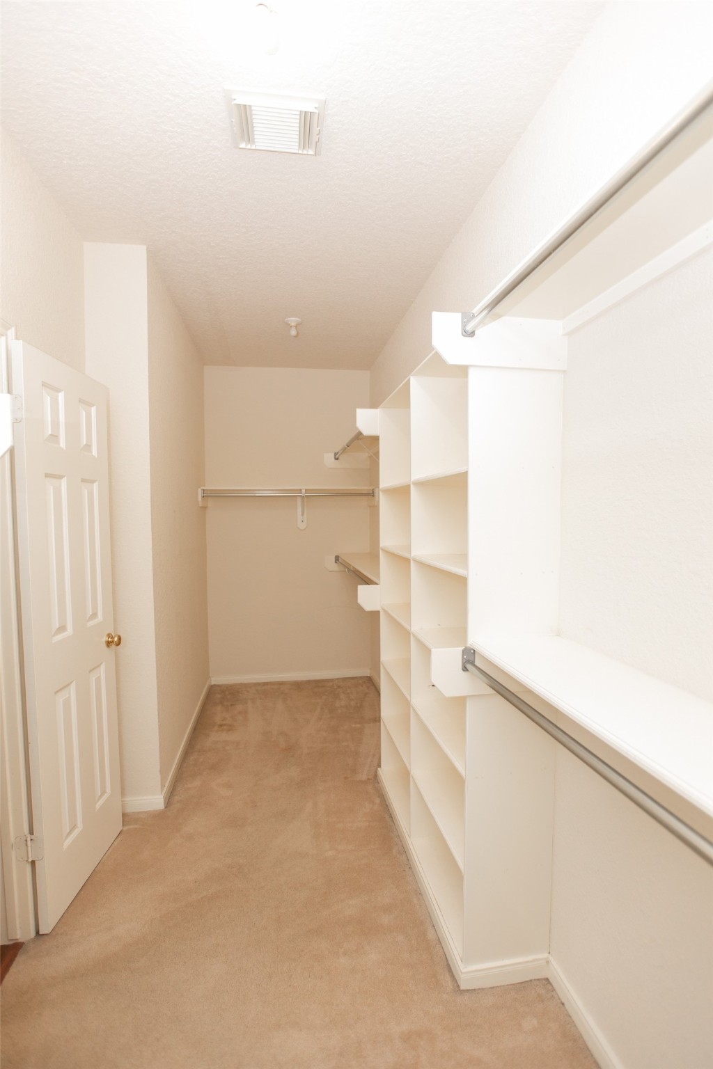 8615 Mile Run Road Humble, TX 77346 - Photo 9 of 16 a view of walk in closet with empty racks