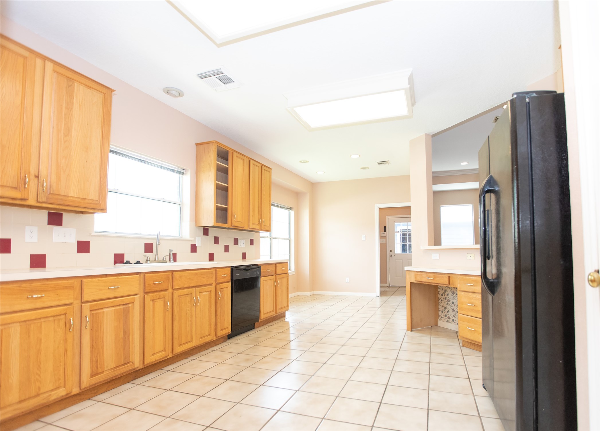 8615 Mile Run Road Humble, TX 77346 - Photo 10 of 16 a large kitchen with a sink and cabinets