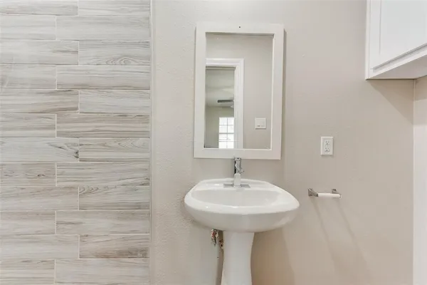 a bathroom with a sink a mirror and a shower