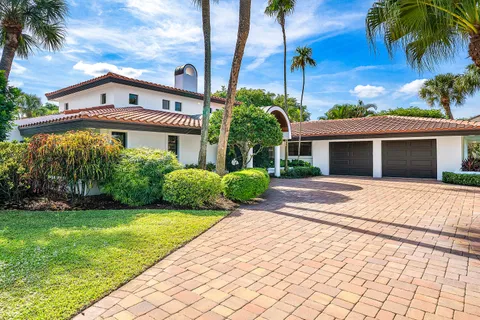 a front view of a house with a yard and a garage