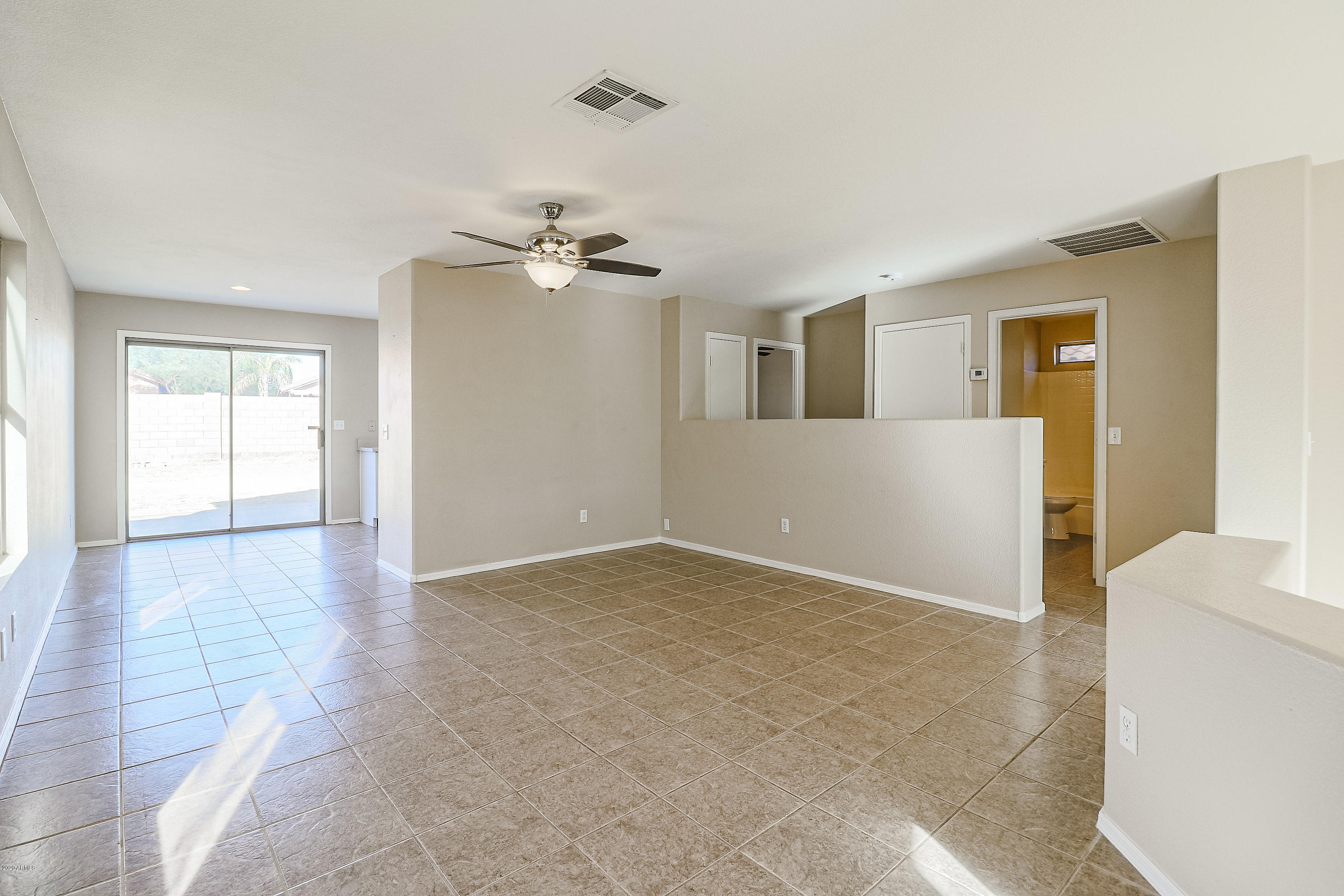 15038 West Redfield Road Surprise, AZ 85379 - Photo 5 of 21 wooden floor in an empty room with a window