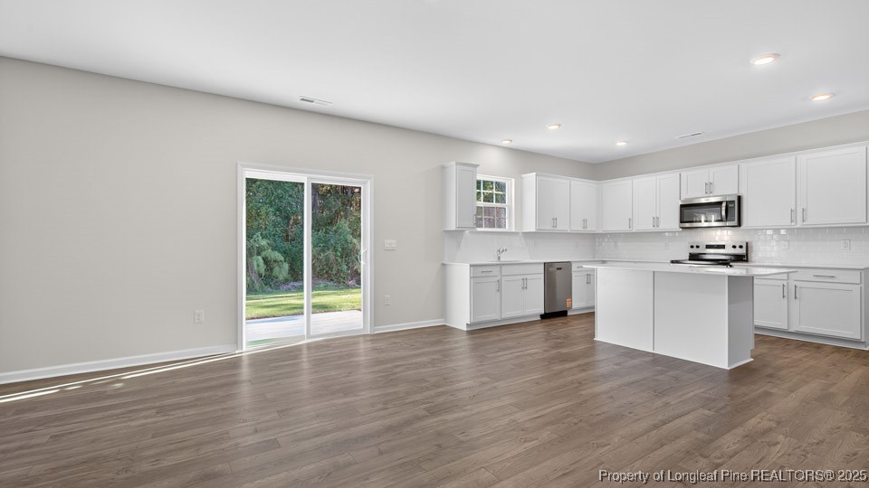 3034 Bayview Drive Vass, NC 28394 - Photo 16 of 47 a view of a kitchen with wooden floor and electronic appliances