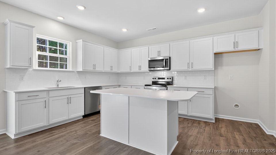 3034 Bayview Drive Vass, NC 28394 - Photo 20 of 47 a kitchen with stainless steel appliances a sink stove and cabinets