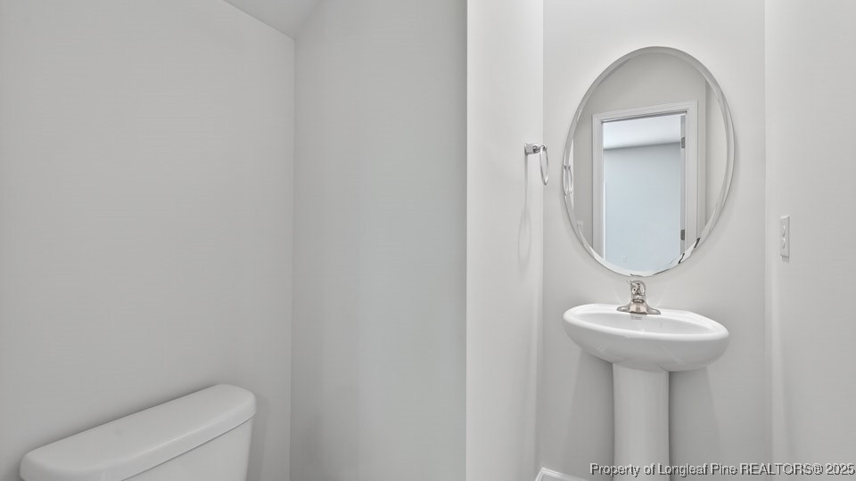 3034 Bayview Drive Vass, NC 28394 - Photo 36 of 47 a bathroom with a sink a toilet and a mirror