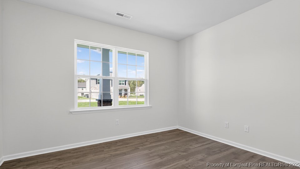 3034 Bayview Drive Vass, NC 28394 - Photo 9 of 47 a view of an empty room with wooden floor and a window