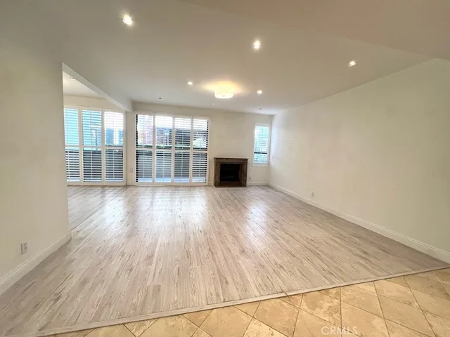 a view of a room with wooden floor and windows