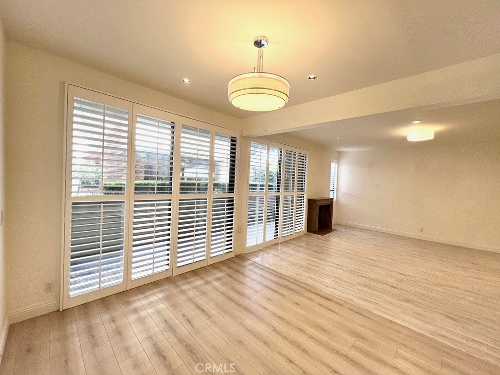 700 South Lake Avenue, Unit 111 Pasadena, CA 91106 - Photo 15 of 40 a view of a room with wooden floor and windows