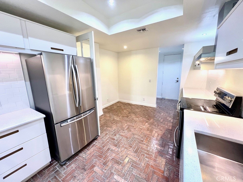 700 South Lake Avenue, Unit 111 Pasadena, CA 91106 - Photo 18 of 40 a view of a refrigerator in kitchen and wooden floor