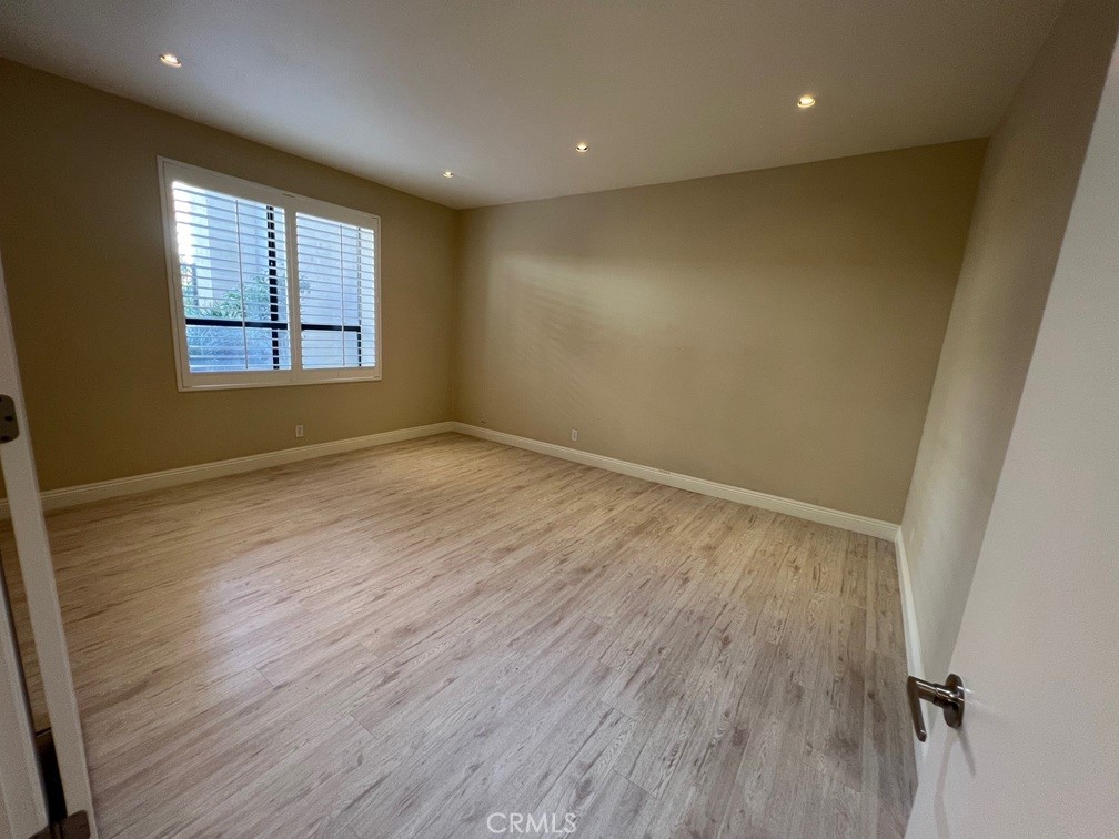 700 South Lake Avenue, Unit 111 Pasadena, CA 91106 - Photo 22 of 40 an empty room with wooden floor and windows