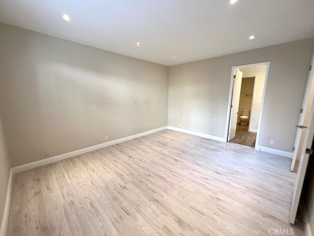 700 South Lake Avenue, Unit 111 Pasadena, CA 91106 - Photo 26 of 40 an empty room with wooden floor and windows