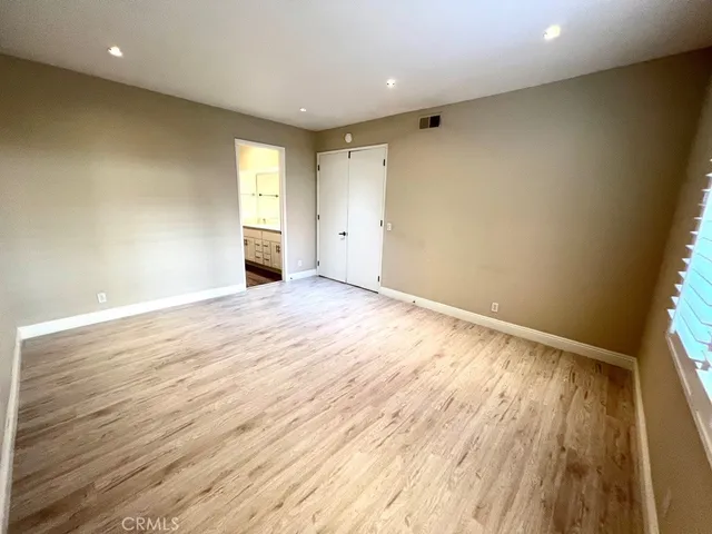 a spacious bathroom with a granite countertop sink mirror and toilet