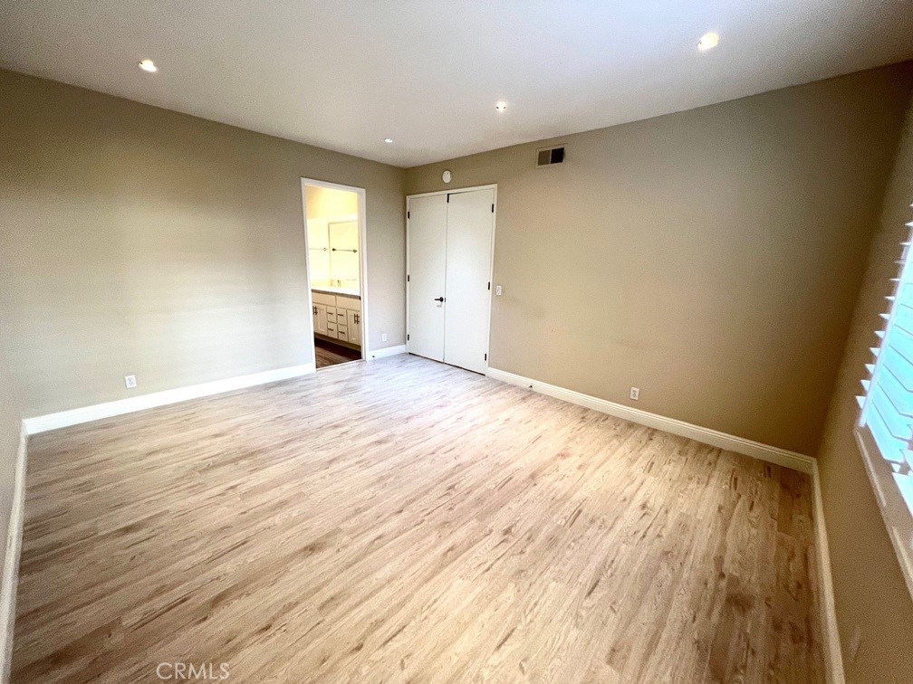 700 South Lake Avenue, Unit 111 Pasadena, CA 91106 - Photo 28 of 40 an empty room with wooden floor and windows