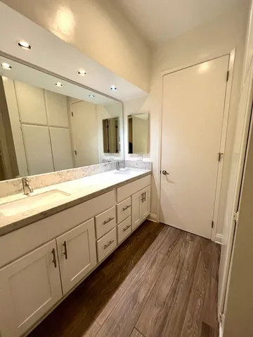 a bathroom with a toilet and a mirror