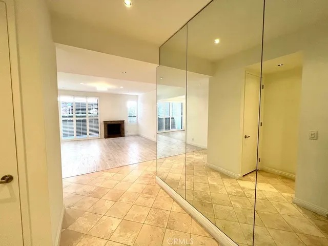 an empty room with wooden floor and fireplace