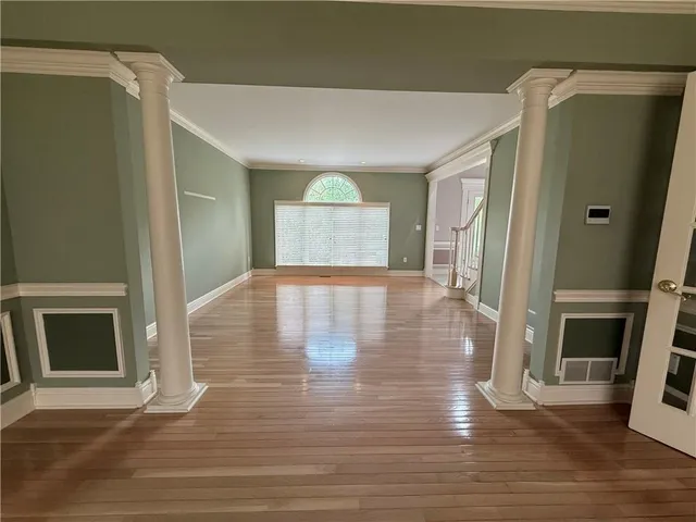 a view of a room with wooden floor and a window