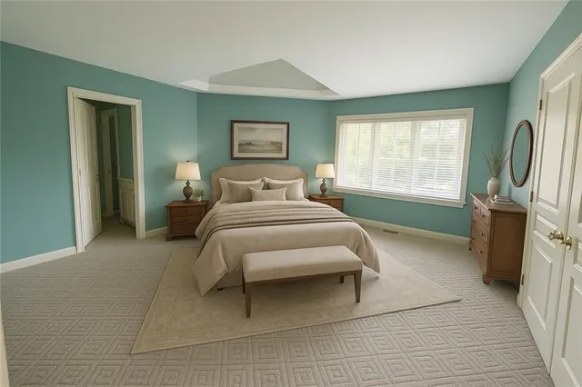 a bedroom with a bed a mirror and a window