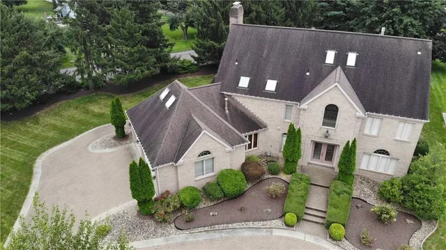 an aerial view of a house with a garden
