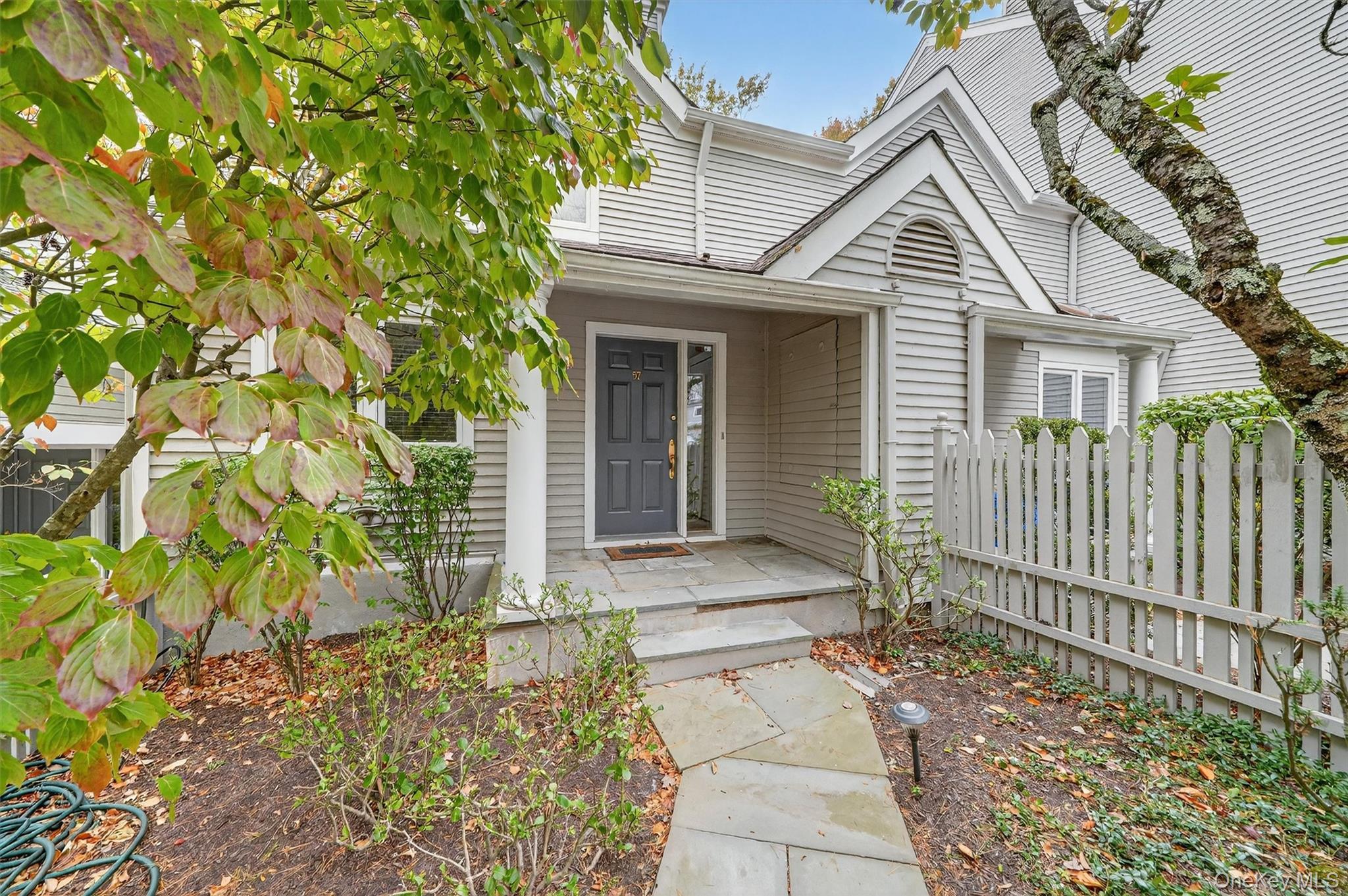 57 Boulder Ridge Road Scarsdale, NY 10583 - Photo 2 of 49 a front view of a house with a small yard