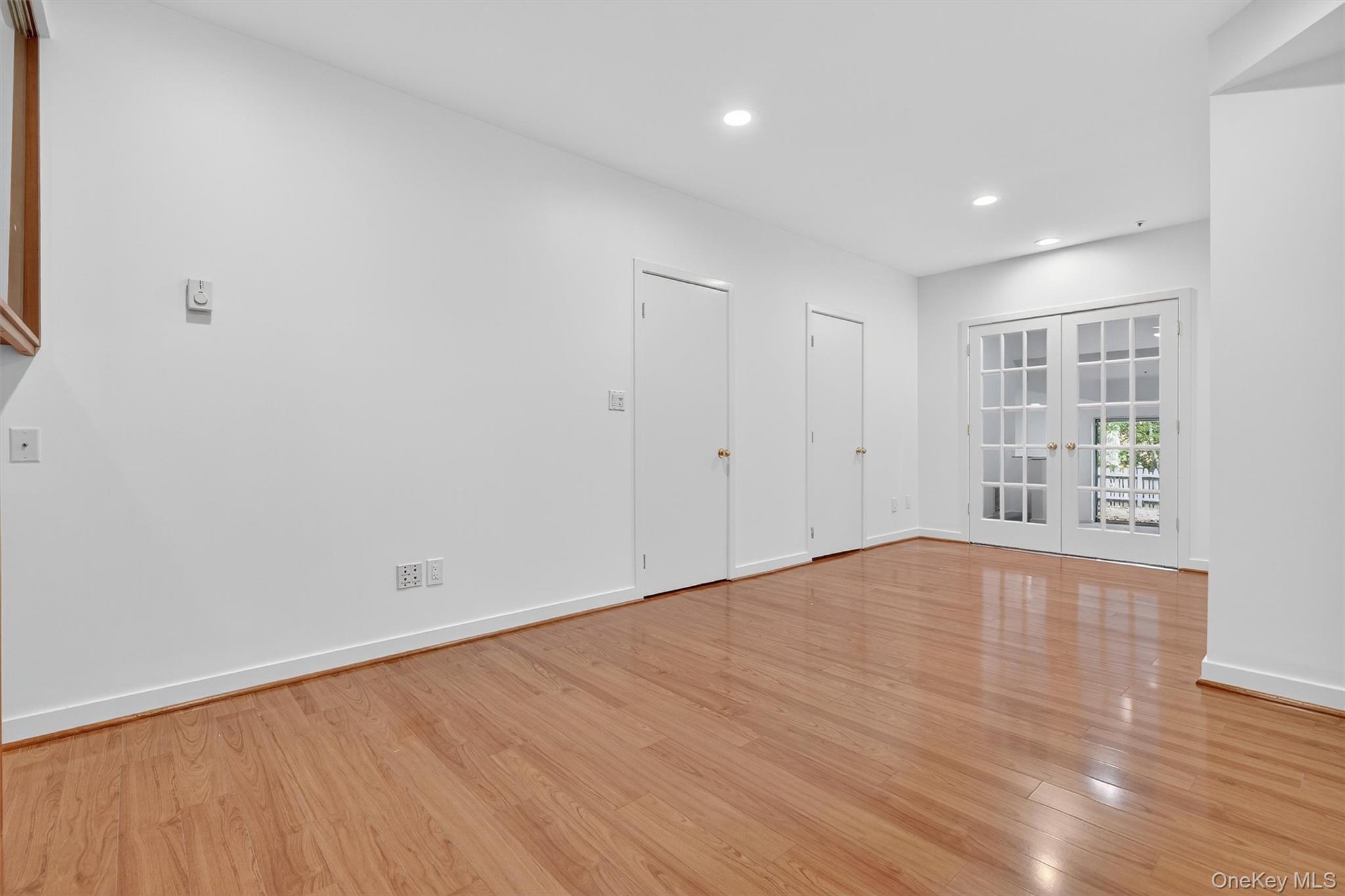 57 Boulder Ridge Road Scarsdale, NY 10583 - Photo 27 of 49 a view of an empty room with wooden floor and a window