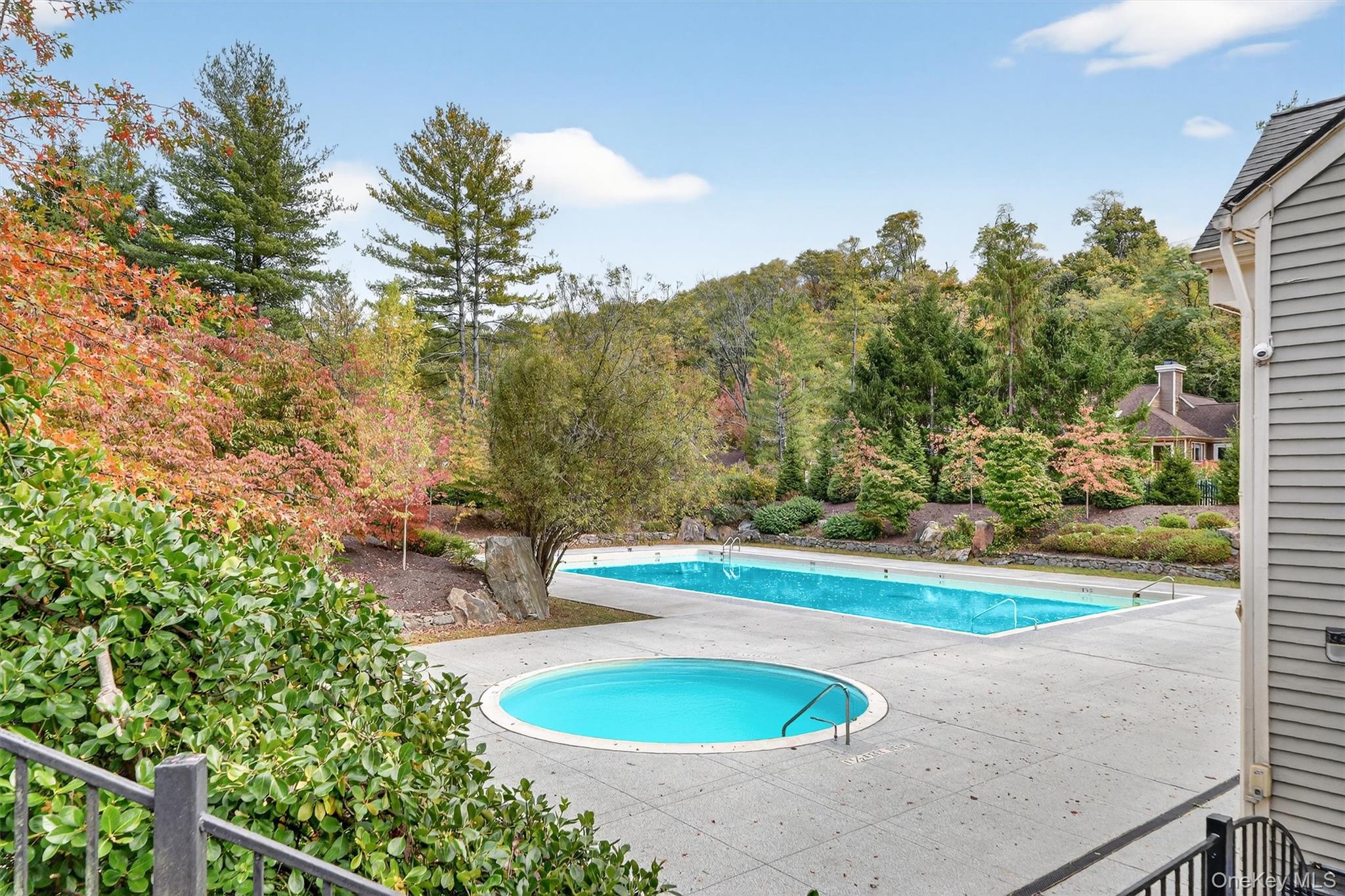 57 Boulder Ridge Road Scarsdale, NY 10583 - Photo 37 of 49 a view of a swimming pool with a yard and outdoor seating